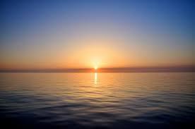 A calm sea with clouds overhead